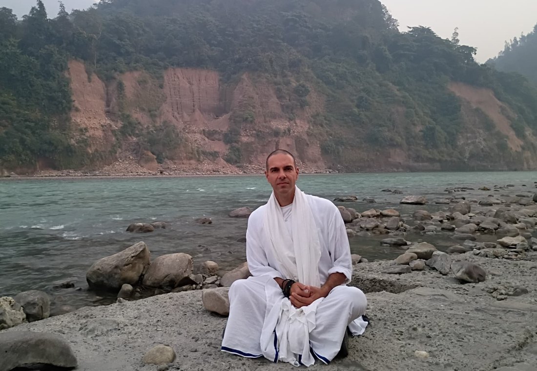 Sahaja Bodha seated on a riverside terrace in Rishikesh